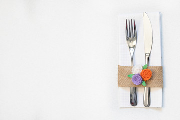 white napkin, knife and fork, place for dinner served in rustic style