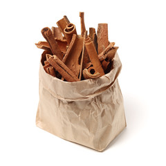 Cinnamon sticks in a paper bag isolated on white background