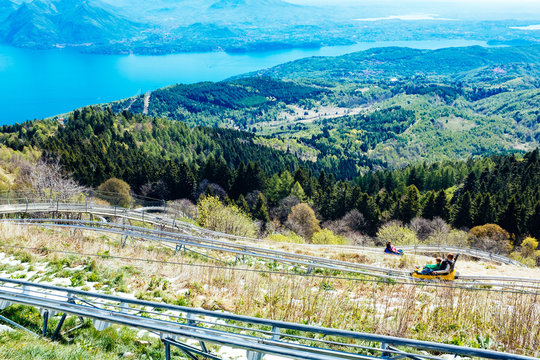 Roller coaster, bob on tracks, in the background Maggiore Lake, Mottarone, Stresa, Italy