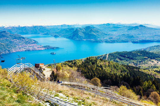 Roller coaster, bob on tracks, in the background Maggiore Lake, Mottarone, Stresa, Italy