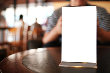 Menu frame space for text marketing promotion standing on wood table in Bar restaurant cafe.