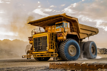 Fototapeta Mining dump trucks transporting Platinum ore for processing obraz