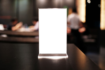 Menu frame standing on wood table in Bar restaurant cafe. space for text marketing promotion.