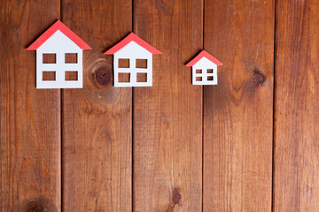 Obraz na płótnie Canvas Three small houses over brown wood