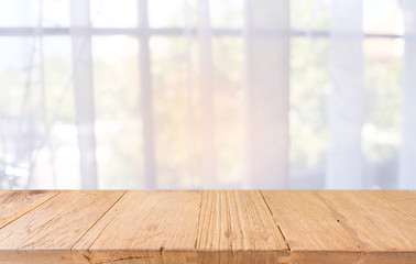 Empty wooden table in front of abstract blurred background of coffee shop . can be used for display or montage your products.Mock up for display of product.