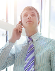 Business Man Talking on Phone in Office Hall