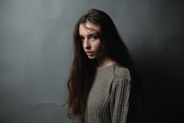 Cute girl in studio on the gray background