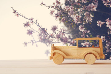 Vintage wooden toy car over wooden table. Nostalgia and simplicity concept.