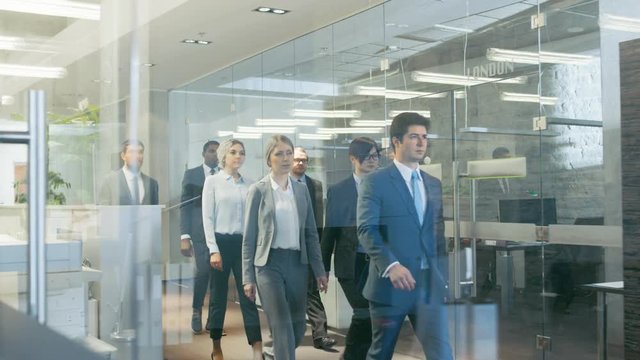 Diverse Team of Delegates/ Lawyers Confidently Marching Through the Corporate Building Hallway. Multicultural Crowd Of Resolute Business People in Stylish Marble and Glass Offices.