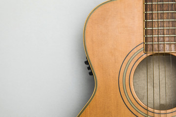 Obraz premium Wooden acoustic guitar against a plain background