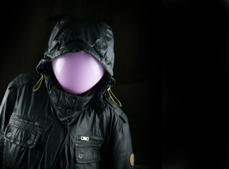 Silhouettes a black jacket with a balloon instead of a head on a black background. The concept of a...