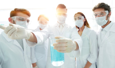 closeup of a group of medical workers working with liquids