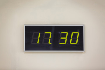 Black digital clock on a white background showing time 17 hours 30 minutes