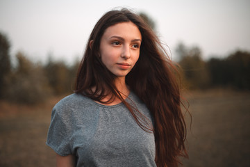 Fototapeta premium A portrait of a young beautiful woman at evening. Close up
