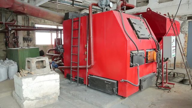 A large boiler for heating industrial premises with alternative fuels and wooden brackets