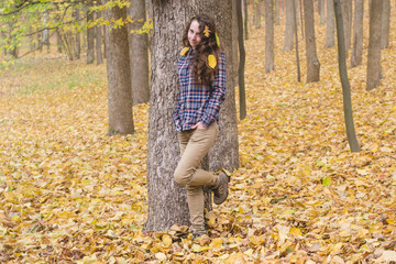 Shy pretty girl walks in the forest. Fallen leaves in her hair