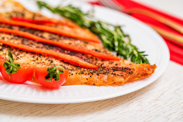 Roasted fish fillet with vegetables close