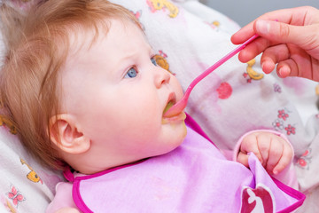 The first feeding of the baby from the spoon.