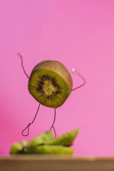 kiwi with arms and legs like a person, different view of a kiwi, surrealism kiwi, kiwi flying in the air 