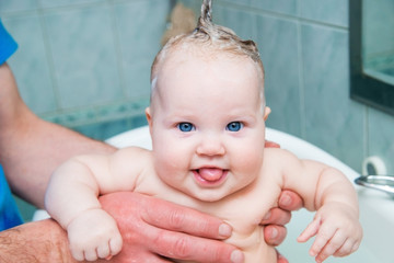 Bathing funny baby in the tub.