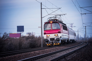 Obraz premium Train ride on the track in dark evening light, travel, transport photo