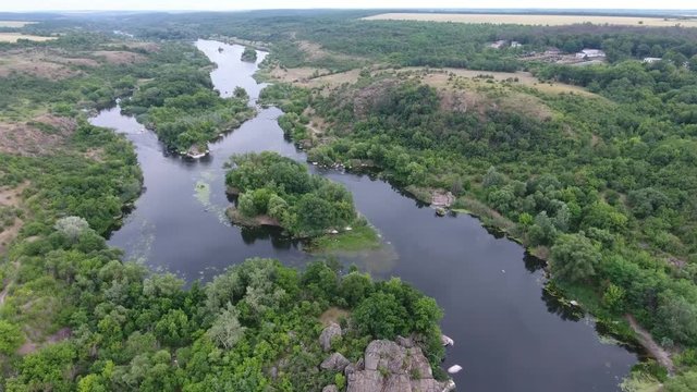 An astonishing bird`s eye view of the Dnipro river basin with small lakes, bubbling inflows, patches of greenery and bulrush on a sunny day