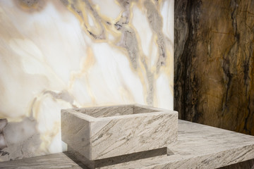 Square washbasin near white and dark marble walls