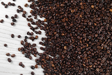 Roasted coffee beans on kitchen table. Top view.