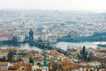 View of Vltava river and Charles Bridge from Prague Castle on rainy day
