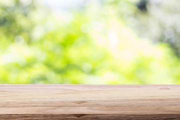 Wood table top on bokeh green bright background. For montage product display or design key visual layout