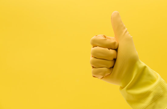Thumbs Up Hand Gesture Made By A Hand In A Yellow Rubber Cleaning Glove