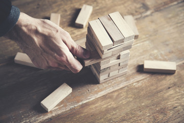 businessman making a pyramid  wooden cubes