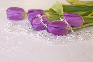 purple pink tulips glass beads on the table, the spring of love the beauty of concrete background