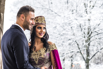 Happy couple in traditional turkish wedding dress during their wedding