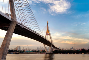 The big rope bridge name Bhumibol Bridge that cross big river to city at sunset in Bangkok, Thailand.