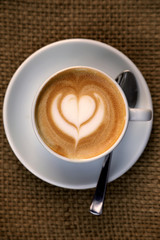 Cappuccino with heart in the froth art, barista coffee