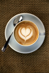 Cappuccino with heart in the froth art, barista coffee