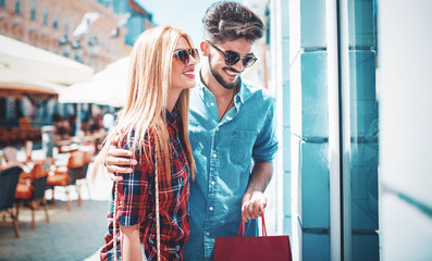 Shopping time. Young couple in shopping. Consumerism, love, dating, lifestyle concept