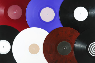 Background of vinyl records DJs for a music player close-up. Red, black, white vinyl records. Retro audio equipment for disc jockey. Sound technology for DJ to mix & play music