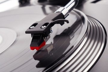 Turntable vinyl record player. Sound technology for DJ to mix & play music. Needle on a vinyl record close-up. Vinyl record player on a background decorations for a party, bright disco lights        