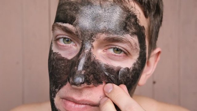 man breaks a cosmetic mask from the face