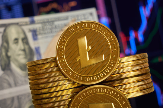 Gold coin litecoin stacked on a bright background of business graphics close-up. Crypto-currency. Anonymous. Virtual currency