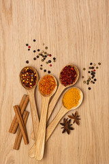 Spice. Spice in a wooden spoon. Herbs. Curry, saffron, turmeric, pepper and others on a wooden background.