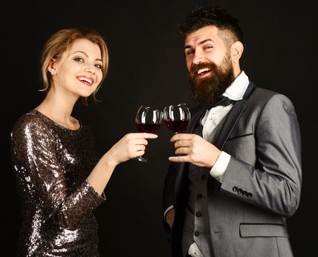 Couple in love holding glasses of red wine