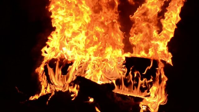 Flames and smoke from tires on the fire. People on protest. Burning tire. Burning flames fire at night.