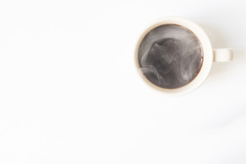 Hot coffee with smoke ready to drink on a white background. View