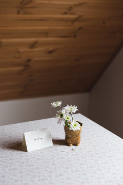 Card next to flowers on a table