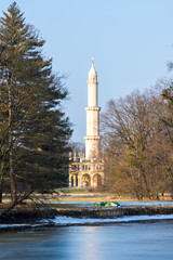 Fototapeta premium Minaret at Lednice castle, Czech Republic historical place, the lake in foreground
