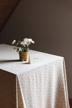 Card next to flowers on a table