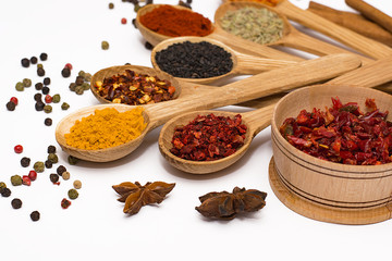 Spice. Spice in a wooden spoon. Herbs. Curry, saffron, turmeric, pepper and other isolated on white background.